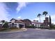 Beautiful clubhouse with stone accents, arched entryway, red tile roof, and well-manicured landscaping at 16907 Verona Place, Lakewood Ranch, FL 34202