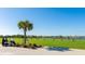 Driving range with golf cart and a person practicing at 17535 Sandpearl Rd, Venice, FL 34293