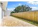 Spacious paved backyard patio with wooden fence at 1756 Livingstone St, Sarasota, FL 34231