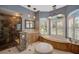 This bathroom has a marble shower, marble counters, and jacuzzi tub with shuttered windows at 2123 Calusa Lakes Blvd, Nokomis, FL 34275