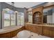 Bathroom featuring a vanity, a soaking tub, and shuttered windows for natural light at 2123 Calusa Lakes Blvd, Nokomis, FL 34275