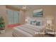 Virtually staged bedroom with a window and a plush bed and matching nightstands at 2123 Calusa Lakes Blvd, Nokomis, FL 34275