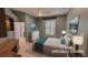 Bedroom virtually staged with rug, bed, lamps, and wall art at 2123 Calusa Lakes Blvd, Nokomis, FL 34275