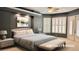 Staged bedroom features a tray ceiling, large windows with white shutters, and recessed lights at 2123 Calusa Lakes Blvd, Nokomis, FL 34275