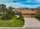 Well-manicured lawns and landscaping complement the home's exterior, creating a welcoming curb appeal at 2123 Calusa Lakes Blvd, Nokomis, FL 34275