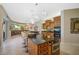 A spacious kitchen features custom cabinets, stone countertops and a large center island with seating at 2123 Calusa Lakes Blvd, Nokomis, FL 34275