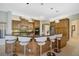 This gourmet kitchen has wood cabinets, granite countertops, a central island, and pendant lighting at 2123 Calusa Lakes Blvd, Nokomis, FL 34275