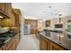 This gourmet kitchen has wood cabinets, granite countertops, and stainless steel appliances at 2123 Calusa Lakes Blvd, Nokomis, FL 34275