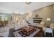 Open-concept living area features a fireplace and pendant lighting in a staged setting at 2123 Calusa Lakes Blvd, Nokomis, FL 34275