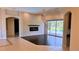 Bright living room features a fireplace, tiled flooring, and large sliding glass doors to outdoor living space at 2123 Calusa Lakes Blvd, Nokomis, FL 34275