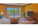 Living room virtually staged with sofa, TV, area rug, and balcony view at 2123 Calusa Lakes Blvd, Nokomis, FL 34275