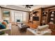 Virtually staged living room features a large bay window and built-in shelving at 2123 Calusa Lakes Blvd, Nokomis, FL 34275