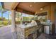 Granite counter tops and stainless steel grill highlight the outdoor kitchen area of this home's screened patio at 2123 Calusa Lakes Blvd, Nokomis, FL 34275