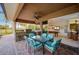 Outdoor kitchen, dining area, and billiard room create a perfect space for entertaining on the covered brick patio at 2123 Calusa Lakes Blvd, Nokomis, FL 34275
