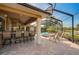 Poolside bar and lounge area with seating offer a luxurious outdoor experience in this beautiful home at 2123 Calusa Lakes Blvd, Nokomis, FL 34275
