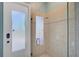 The glass shower features tile backsplash and a door to the outside at 2123 Calusa Lakes Blvd, Nokomis, FL 34275