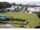 A sunny community featuring single-story homes surrounded by lush green spaces and palm trees at 2815 Us-41 N, Palmetto, FL 34221