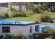 Single-story home with a tarp on the roof and overgrown landscaping at 2815 Us-41 N, Palmetto, FL 34221