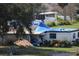 Damaged house with blue tarps covering roof at 2815 Us-41 N, Palmetto, FL 34221