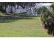 Open field with distant home and palm trees at 2815 Us-41 N, Palmetto, FL 34221