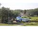 House exterior showing storm damage with blue tarp covering roof at 2815 Us-41 N, Palmetto, FL 34221