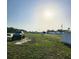 The wide, grassy property features cars, a black truck, and mobile homes in the distance at 2815 Us-41 N, Palmetto, FL 34221