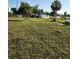 A grassy field with mature landscaping and a for-sale sign offers potential for building your dream home at 2815 Us-41 N, Palmetto, FL 34221