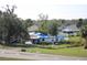 A property featuring damaged roofs and blue tarps in need of repair situated on a grassy lot at 2815 Us-41 N, Palmetto, FL 34221