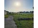 A grassy field in a mobile home park under a sunny sky offers potential for new beginnings at 2815 Us-41 N, Palmetto, FL 34221