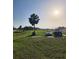 A grassy field with mature landscaping and vehicles offers potential for building your dream home at 2815 Us-41 N, Palmetto, FL 34221
