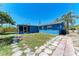 Spacious backyard with a stone walkway and grassy area, perfect for outdoor entertaining and relaxation at 2820 Wood St, Sarasota, FL 34237