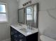 Modern bathroom with a double sink vanity, white countertops, and framed mirrors at 2820 Wood St, Sarasota, FL 34237