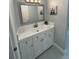 Updated bathroom featuring a modern vanity with bright white cabinets and countertop and decorative mirror at 2820 Wood St, Sarasota, FL 34237