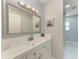 Bright bathroom featuring white cabinets, countertops, and a sleek mirror at 2820 Wood St, Sarasota, FL 34237