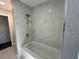 This bathroom features a modern marble tiled shower over a bathtub at 2820 Wood St, Sarasota, FL 34237