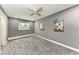Bedroom featuring gray walls, plush carpet and a ceiling fan, offering a cozy space at 2820 Wood St, Sarasota, FL 34237
