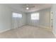 Bright bedroom featuring plush carpeting, a ceiling fan, and natural light from two large windows at 2820 Wood St, Sarasota, FL 34237