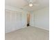 This bedroom features plush carpeting, a ceiling fan, and ample closet space at 2820 Wood St, Sarasota, FL 34237