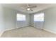 Airy bedroom filled with natural light features windows dressed with sheer curtains at 2820 Wood St, Sarasota, FL 34237