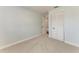 Neutral bedroom with plush carpeting and a closet with louvered doors, ready for personalization at 2820 Wood St, Sarasota, FL 34237