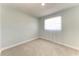 A clean bedroom featuring plush carpeting and a window for natural light at 2820 Wood St, Sarasota, FL 34237