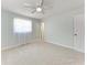 Neutral bedroom with white trim and doors, showcasing a ceiling fan, carpet, and natural light at 2820 Wood St, Sarasota, FL 34237