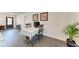 A light dining area featuring hardwood floors, a table, and artwork at 2820 Wood St, Sarasota, FL 34237