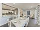 Dining area with an elegant table setting, open to a kitchen with a breakfast bar at 2820 Wood St, Sarasota, FL 34237