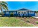 Charming blue home with a manicured lawn and landscaping, evoking a welcoming and vibrant curb appeal at 2820 Wood St, Sarasota, FL 34237