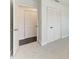 Hallway features a double closet with white doors and neutral carpeting at 2820 Wood St, Sarasota, FL 34237