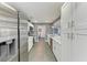 Galley kitchen boasting stainless steel appliances, white cabinets, and tile flooring at 2820 Wood St, Sarasota, FL 34237