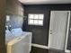 This laundry room features a utility sink, window, and gray walls at 2820 Wood St, Sarasota, FL 34237