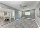 Living room with plush carpet, a ceiling fan, and easy access to the dining area at 2820 Wood St, Sarasota, FL 34237
