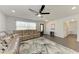 Comfortable living room with a plush sectional sofa and ceiling fan, perfect for cozy evenings at 2820 Wood St, Sarasota, FL 34237